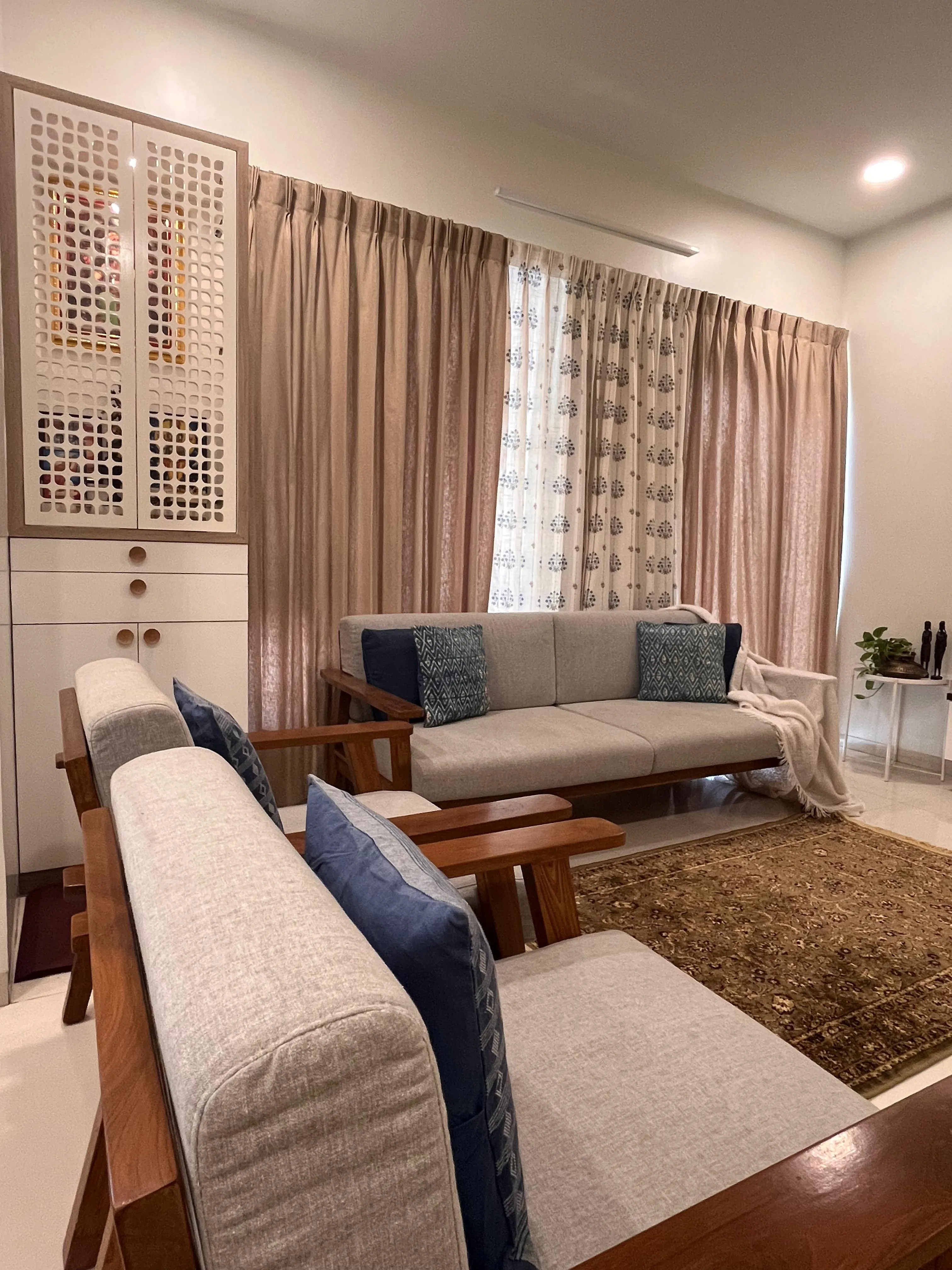 Living area showing the minimal TV unit and cozy seating
