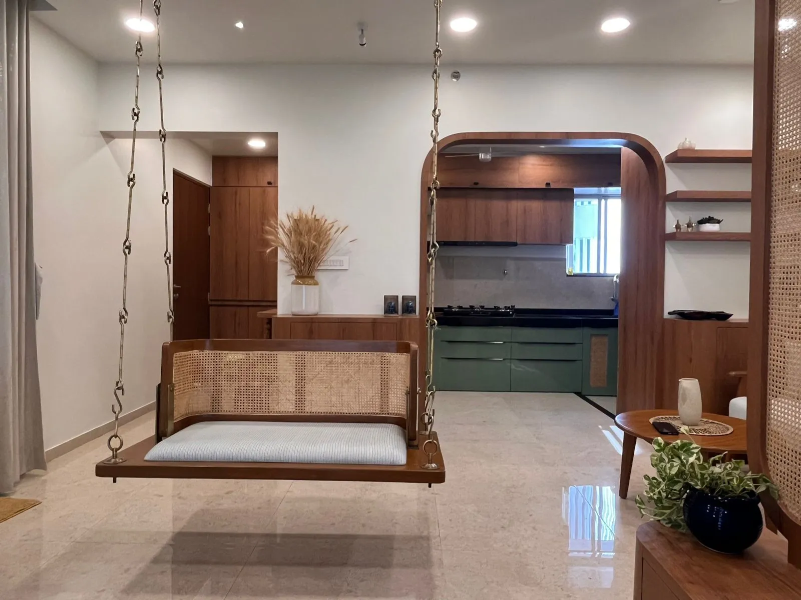 Open living and dining space of the Baner apartment in warm white oak and off-white tones